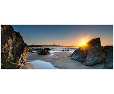 Wallario Acrylglasbild Sonnenuntergang hinter einem Felsen am Strand - 50 x 125 cm in Premium-Qualität: Brillante Farben, freischwebende Optik