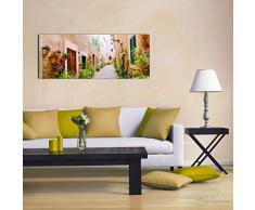 Wallario Glasbild Südländische Gasse mit Alten Häusern und grüner Oase - 50 x 125 cm in Premium-Qualität: Brillante Farben, freischwebende Optik
